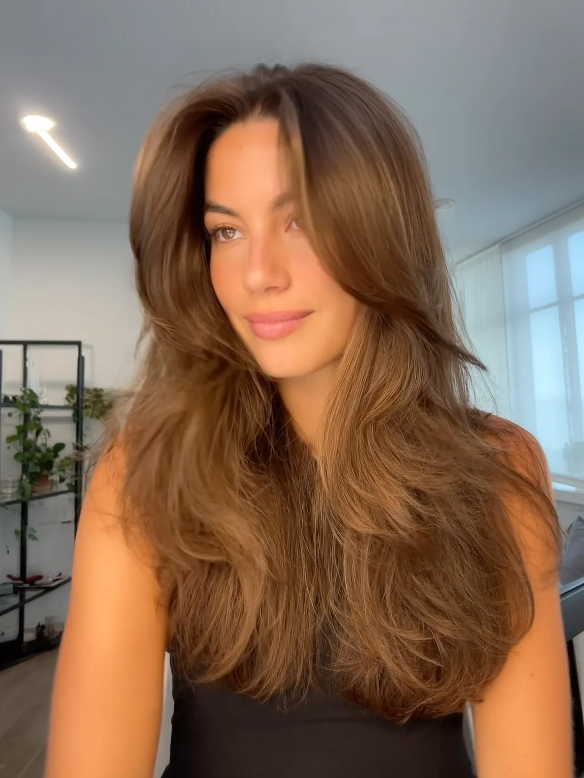 Voluminous Long Layers with Warm Caramel Curtain Bangs